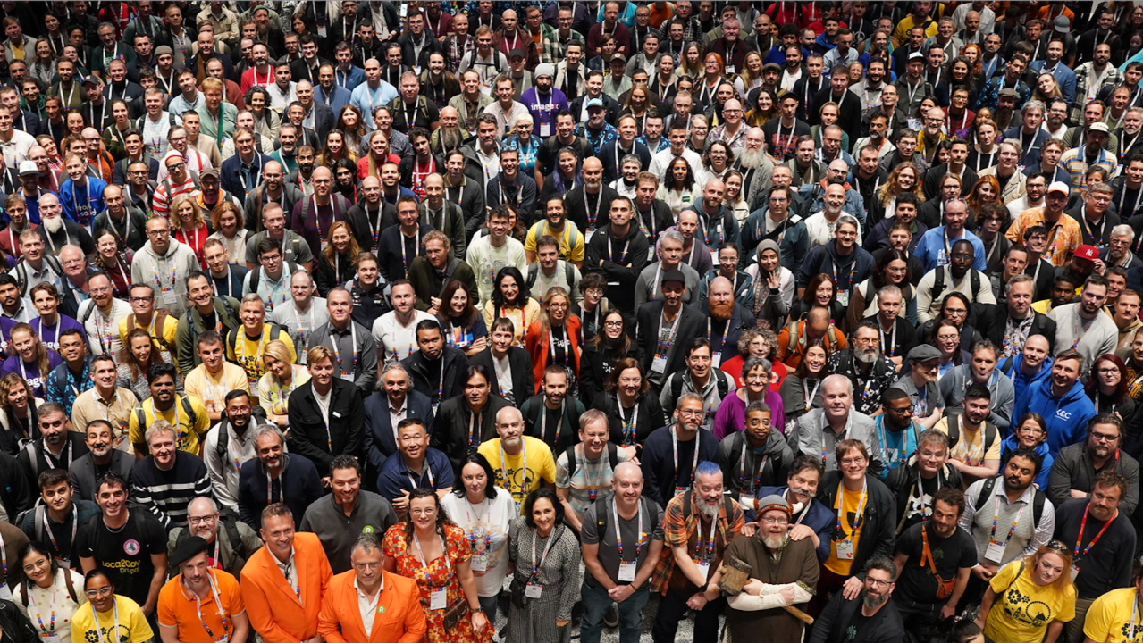 Eine große Menschenmenge, von oben fotografiert, posiert für ein Gruppenfoto.